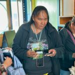 Photo of Indigenous attendees getting their free gifts for attending.