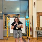 Photo of Jen Deerinwater speaking into a microphone.