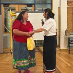 Photo of Lorraine Clements giving Monique May her gift for speaking at the event.