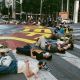 Protestors lay near the street mural they painted to call out large climate disaster financiers. Photo credit: Steph Viera, November 25, 2022