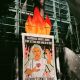 A poster that reads, "BlackRock, Banks, and Biden: Stop Setting Our World On Fire, Defund Climate Chaos" stands tied to a tree near BlackRock headquarters. Photo credit: Steph Viera, November 25, 2022