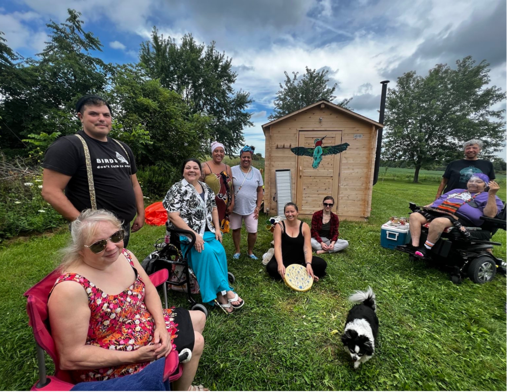 Toronto Indigenous community members and members of No More Silence gather for the ceremony in the Hummingbird Lodge with Wanda Whitebird. Photo credit: Audrey Huntley