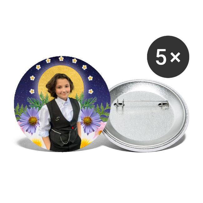 A Round Button is pictured with the Rest in Sacredness design that features a photo of a a starry sky, Nex Benedict is standing in front of a halo-like circle and is surrounded by flowers against a white background.
