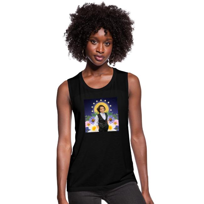 A woman is wearing the Rest in Sacredness Tank in Black that features a photo of a a starry sky, Nex Benedict is standing in front of a halo-like circle and is surrounded by flowers against a white background.