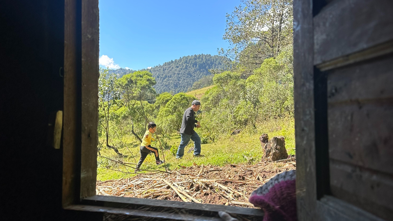 A great uncle and his nephew walking up a hill of their great great uncle's home. When Indigenous families decide to leave their territories, they leave history and generational family connections. This picture was taken in San Juan Ixcoy, Guatemala. Photo credit: Lucero Gonzalez Alvarado, December 29, 2022