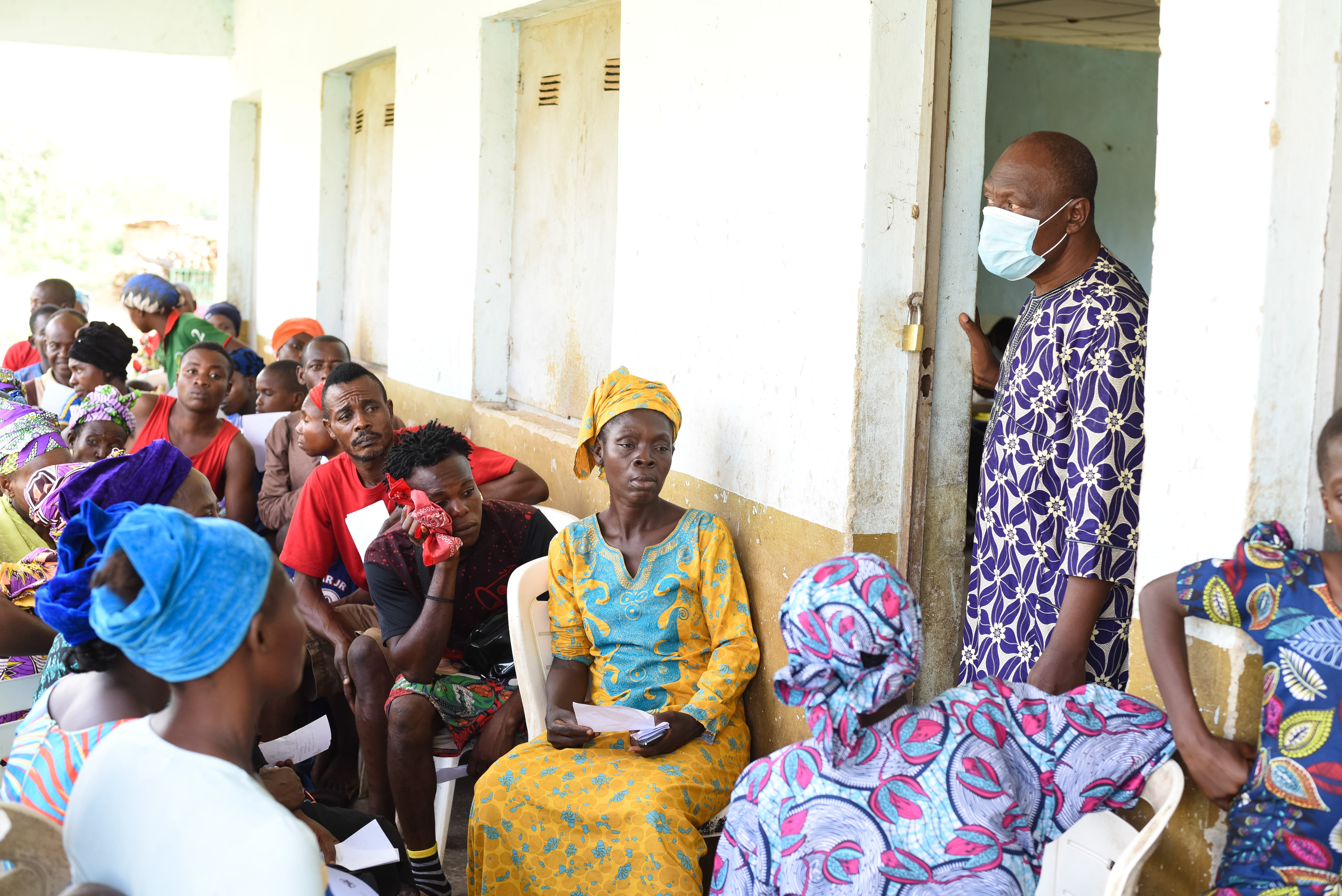 Residents of Langbin community gather in the waiting area as Mr. Adeboye coordinates the flow of patients during the medical outreach in the community. His role was central to managing the high volume of over 250 people, ensuring that each individual moved efficiently from the initial briefing to their clinical consultations and pharmacy pick-ups. Photo credit: Bukunmi Oyewole, December 11, 2020.