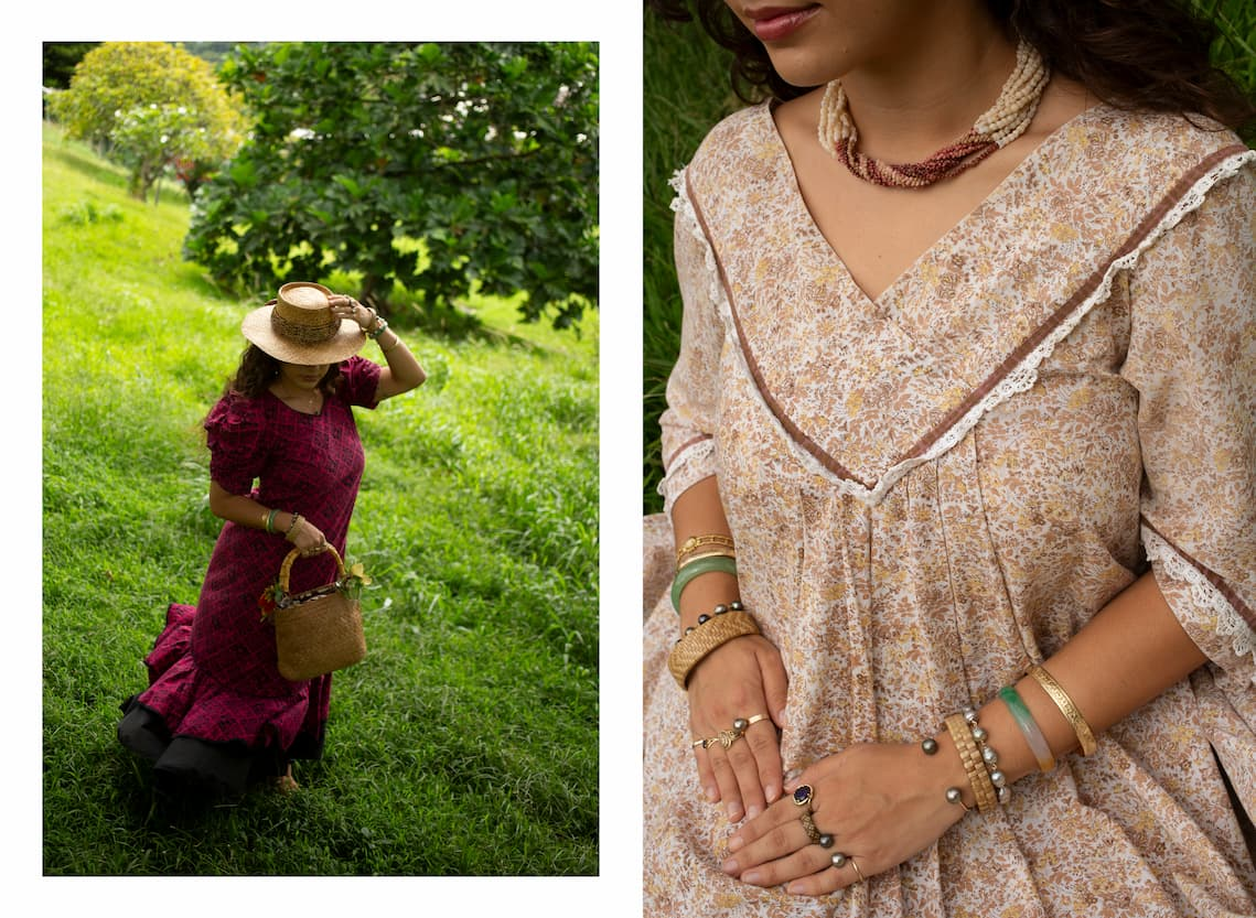 The image displays two panels. The left panel showcases a woman in a floor-length magenta dress with a small repeating black quilt pattern running its length. The dress has puffed sleeves that stop above her elbows and two tiers of ruffles billowing in the wind at the hem, with the bottom ruffle made of solid black fabric. She holds a small square woven purse in her right hand, decorated with yellow and red flower hair clips. She secures her hat to her head gently with her left hand. The hat is woven in light brown and circled on the brim with a black-and-tan striped feather lei. She stands on a sloped green hillside in long grass backdropped by an ʻulu (breadfruit) tree and plumeria trees. The right panel is a close-up of a woman's seated torso, revealing the details of the brown vintage dress she wears that has a white and darker brown lace trim. The woman is wearing several strands of tiny tan and maroon shells twisted together into a choker necklace. Her hands rest in her lap, showcasing stacks of bracelets and rings made of gold, pearls, jade, and lauhala on both of her wrists and all of her fingers.